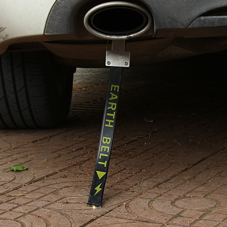 Car grounding belt with EARTH BELT text staked on pavement near wheel