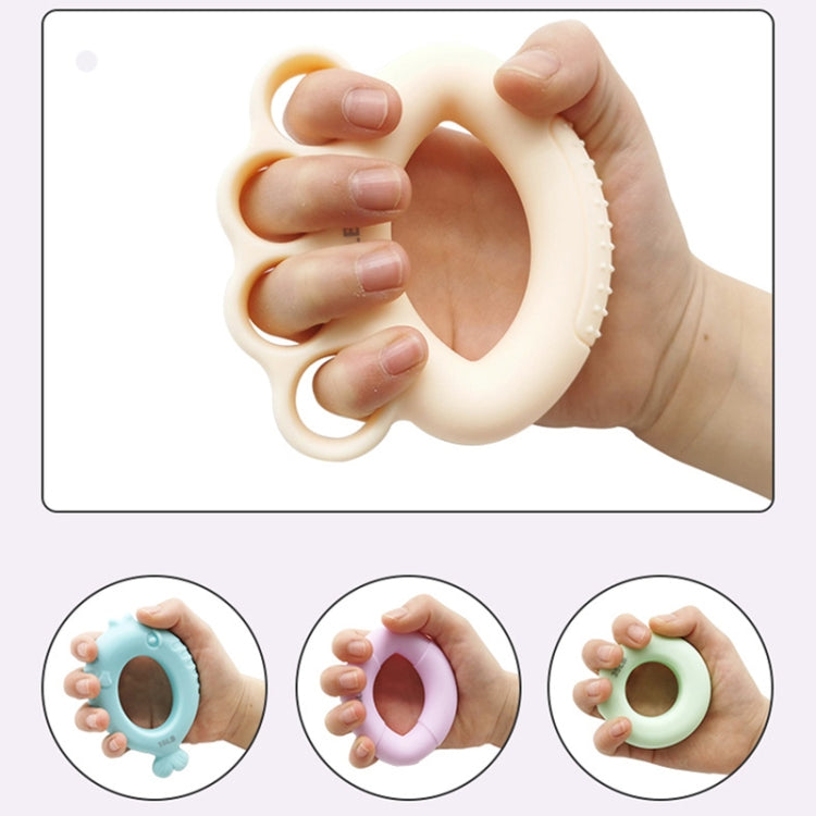 Children’s finger strength training grip ring in hand, off-white ring device