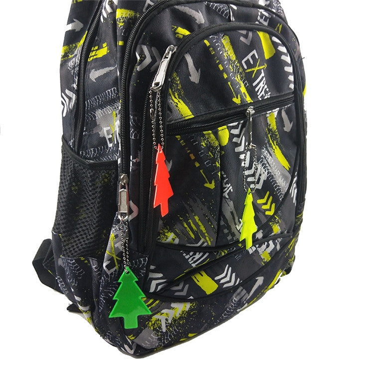 Reflective Christmas tree PVC keychain pendants clipped on black patterned backpack
