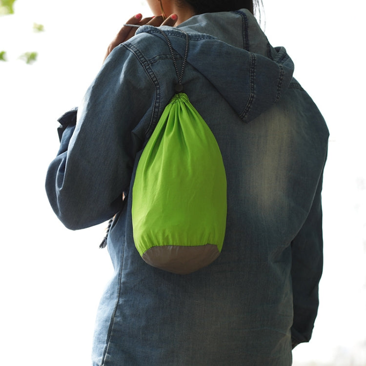 Portable hammock with black fabric and attached green storage pouch