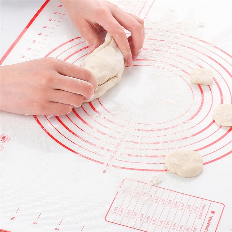 Red-lined silicone kneading mat with dough pieces, circular measurement rings visible