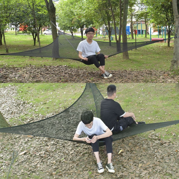 Black triangular mesh hammock tent used by two people while lounging outdoors