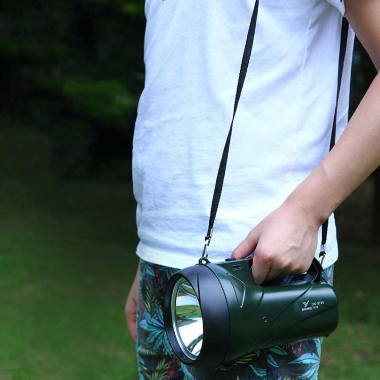 Green portable flashlight with shoulder strap, held by person