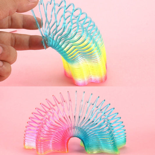 Rainbow glitter transparent spring comb hair toy in wave shapes, held in hand