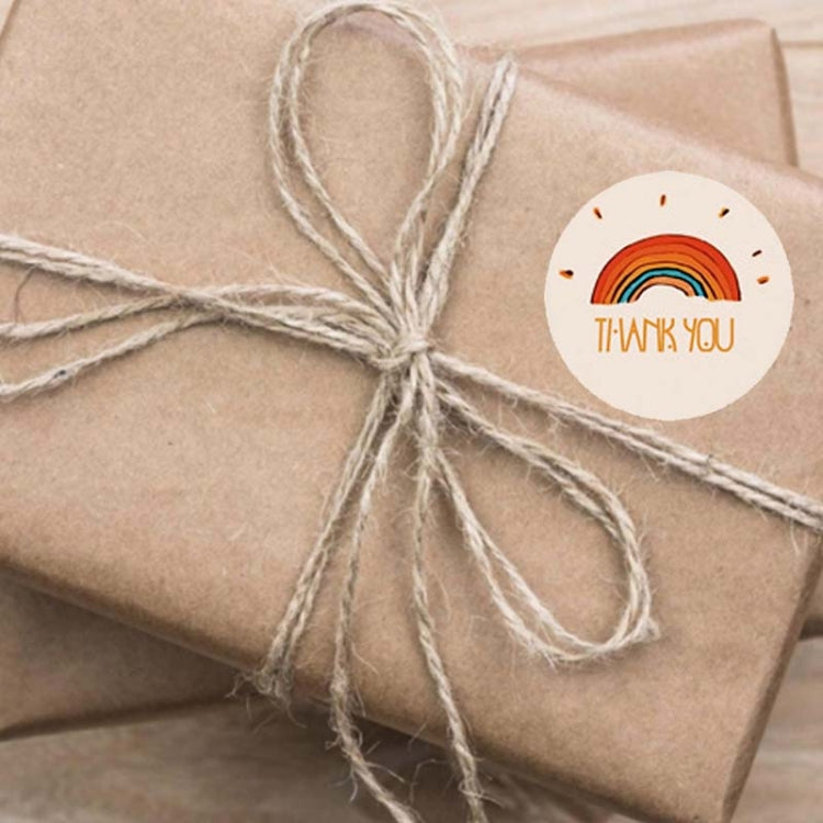 Weatherproof sticker on brown wrapped gift with twine bow and round “Thank you” label