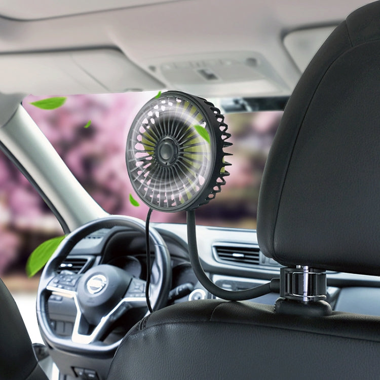 Car USB fan mounted on headrest with flexible neck and round grille, blades in motion