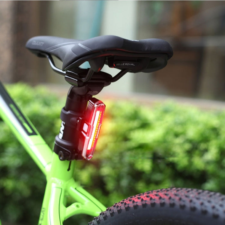 Bicycle tail light mounted on seatpost with red glowing LED bar