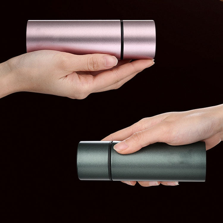 Pink stainless steel insulated mini water cup held in hand