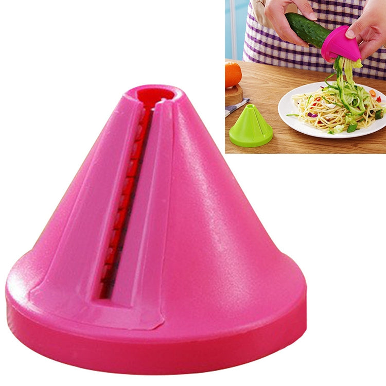 Pink funnel spiral slicer vegetable shredder in use on a plate