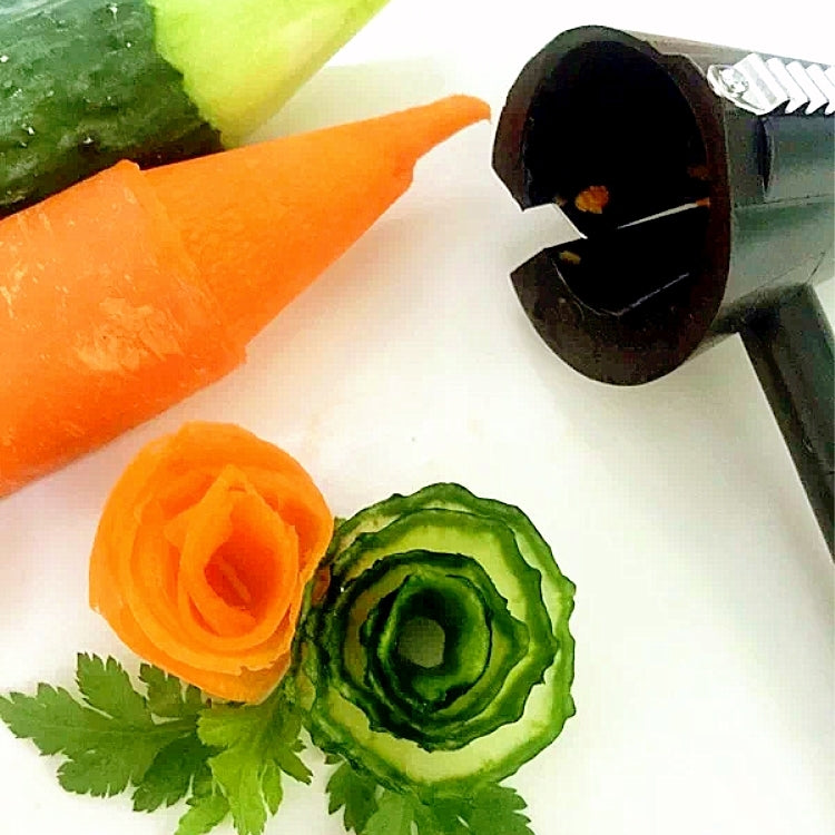 Black spiral slicer creating cucumber and carrot rose-shaped spirals