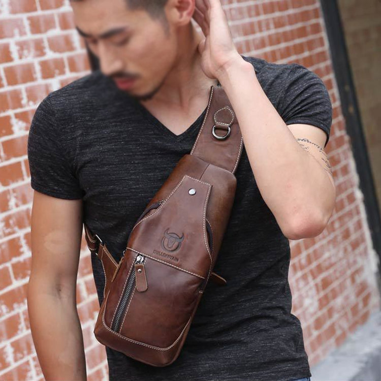 Brown leather crossbody chest bag worn diagonally across chest with front zipper pocket