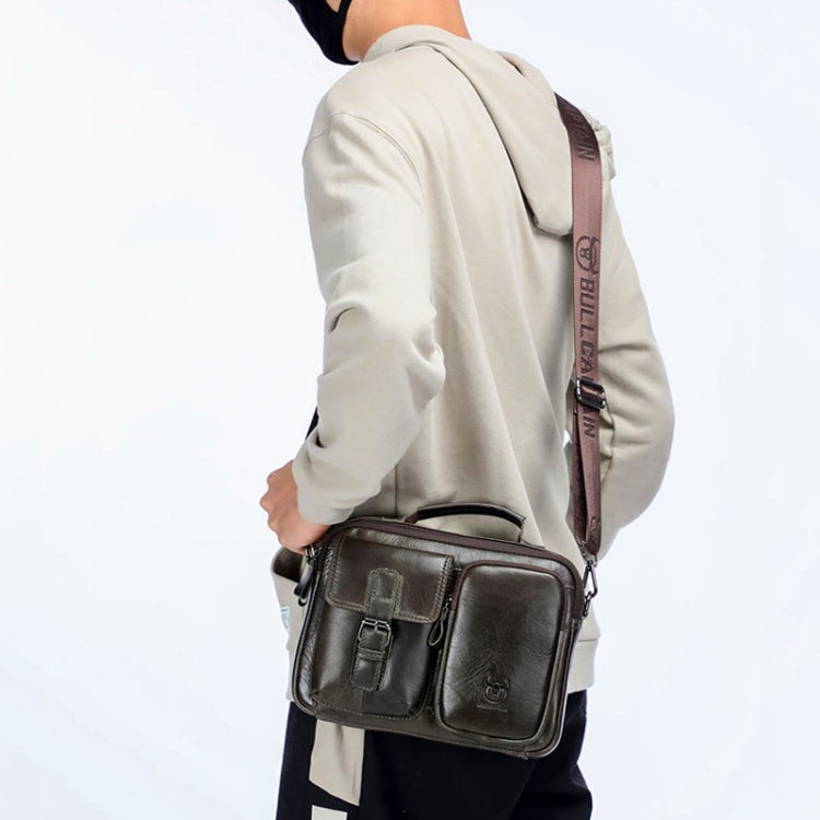 Dark leather messenger bag with flap, front buckle pockets, and shoulder strap