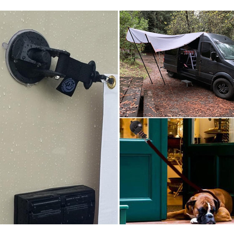 Suction cup hook with black strap installed on a wall surface for holding gear