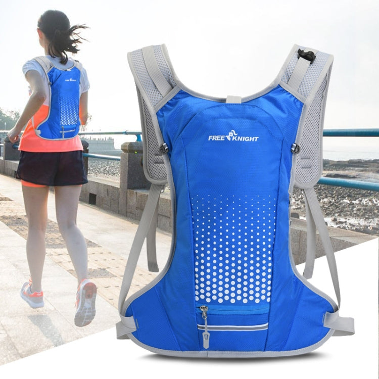 Blue hydration water bag vest backpack worn, with reflective dot panel and front water hose port