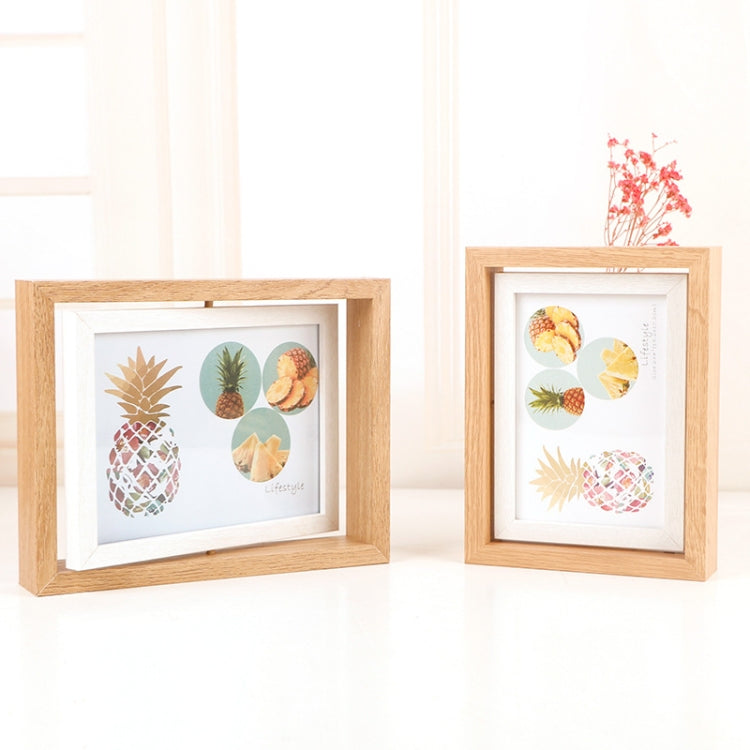 Two light wood tabletop photo frames displaying pineapple collage prints, angled apart