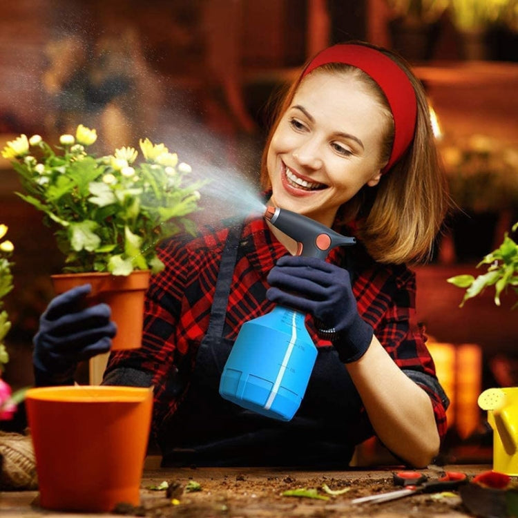 Blue electric disinfection sprayer bottle with nozzle, held in hand