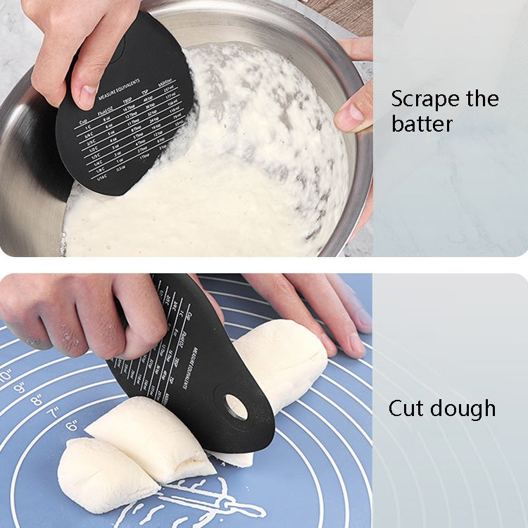 Black silicone scraper wiper pressed to dough on silicone mat, measurement chart visible