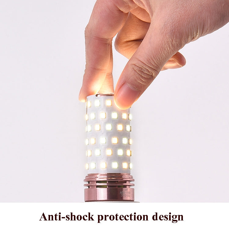 LED corn candle bulb lit, hand adjusting the bulb top near the screw base