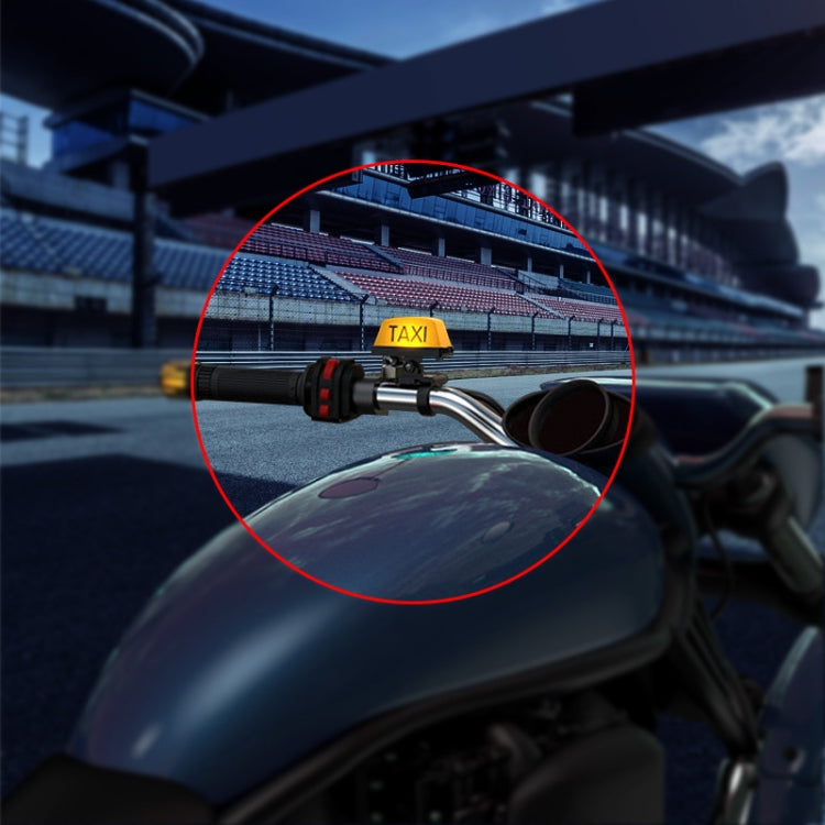 Taxi-style yellow TAXI motorcycle warning light mounted on a bike handlebar