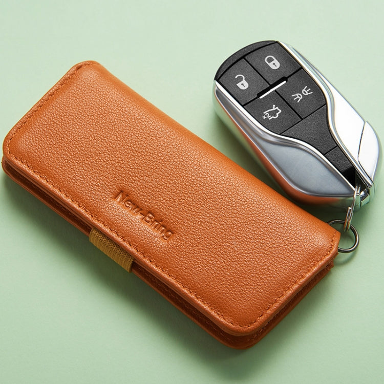Orange leather key case with key fob stored and metal key ring loop