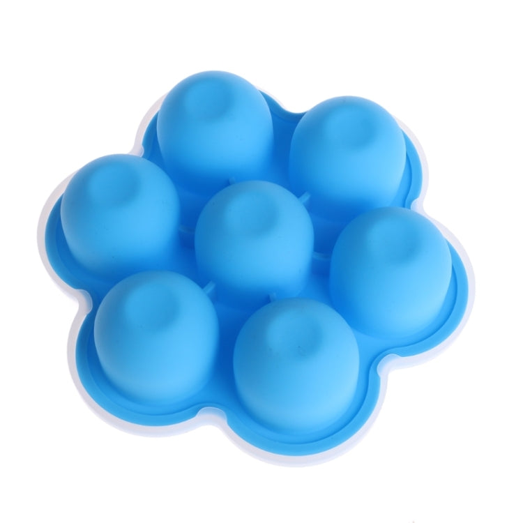 Blue 7-grid silicone baby food tray filled with rounded frozen portions