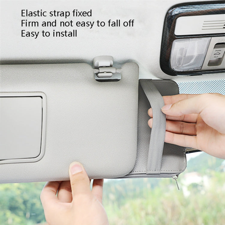 Car visor card organizer clip with gray elastic strap being installed