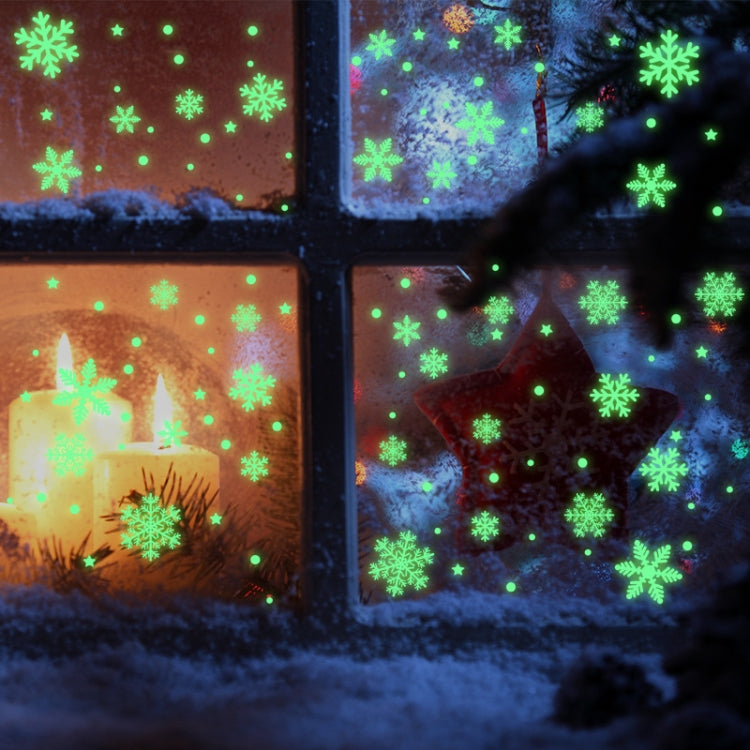 Luminous green snowflake and dot window stickers at night with snowy background