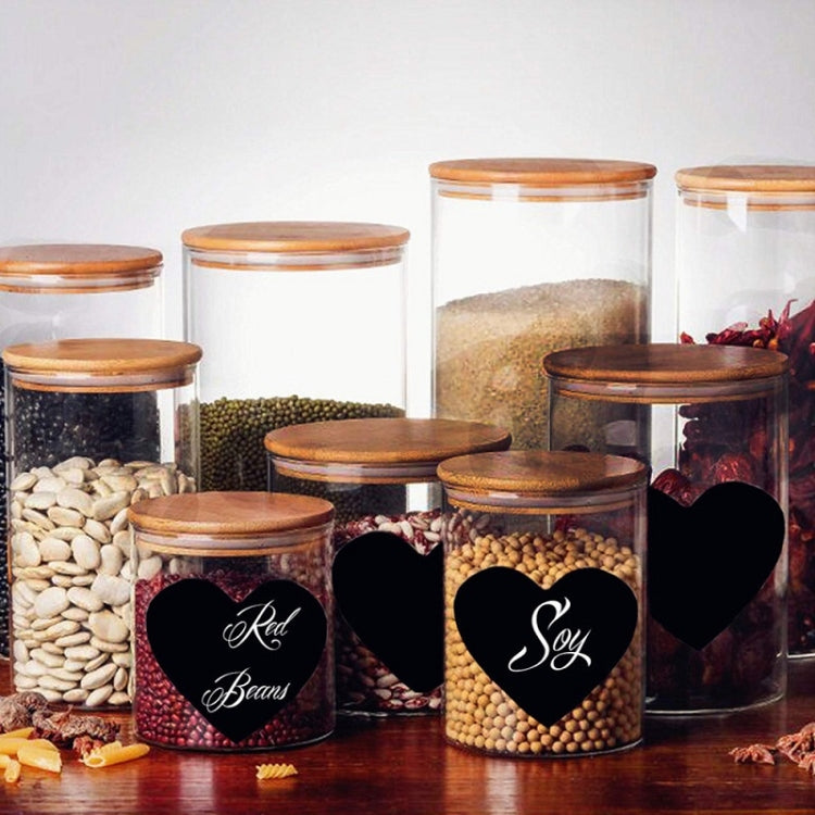 Heart-shaped labels on pantry jars for food marking, black hearts with cursive names