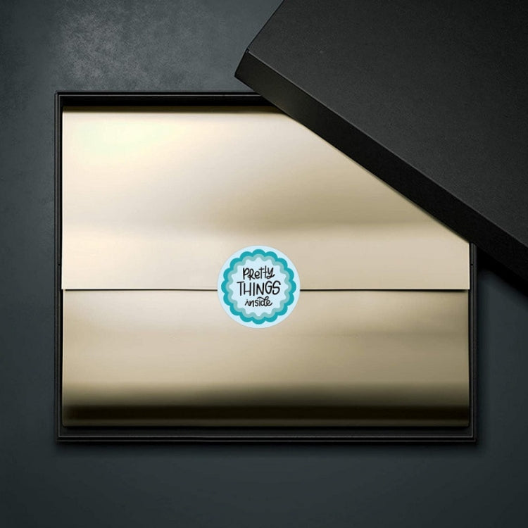 Blue circular "pretty things inside" sealing sticker on envelope flap