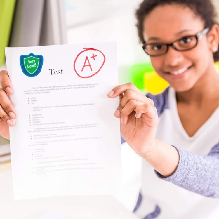 Teacher reward stickers on a paper test, including a blue “Very Good!” badge and red A+