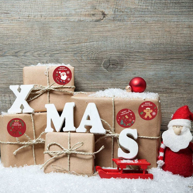 Christmas gift packages with small round “Merry Christmas” sticker seals on kraft boxes