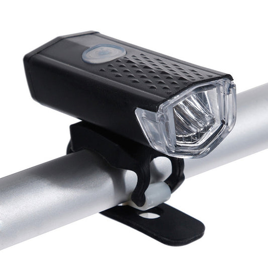 Black bicycle front headlight with clear lens, mounted on handlebar