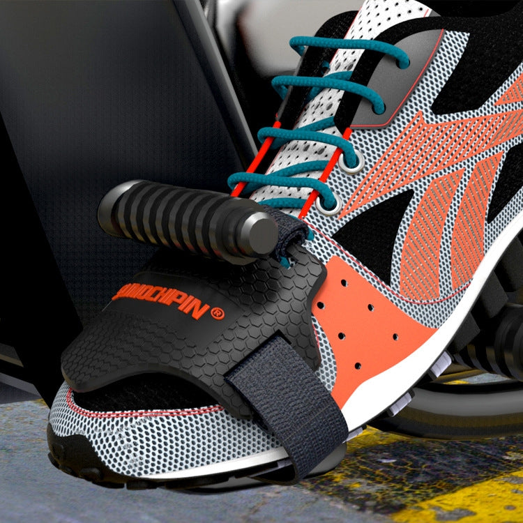 Motorcycle shoe cover worn on sneaker; black textured cover with elastic strap