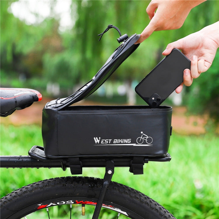 Black rear seat bike storage bag with hands placing a phone into the top opening