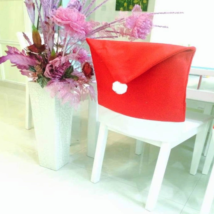 Red Santa hat chair back cover with white trim and small pom-pom on chair back
