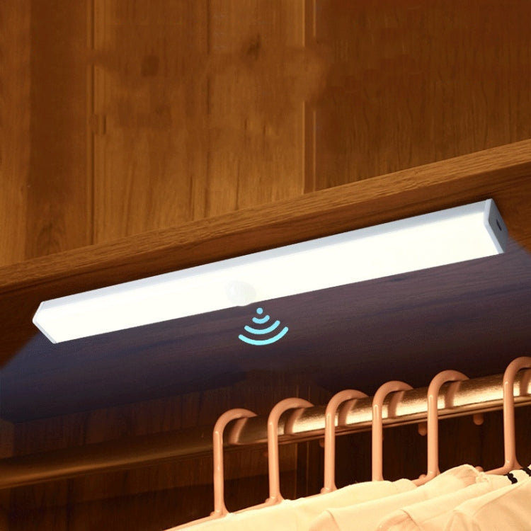 LED induction cabinet light strip with sensor icon under wooden shelf