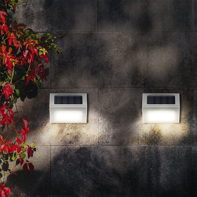 Two stainless steel solar LED stair wall lights with warm outdoor wall glow