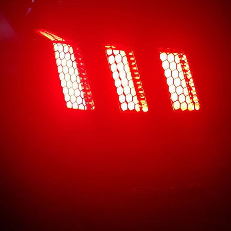 Honeycomb tail light film detail with glowing red hexagon grid