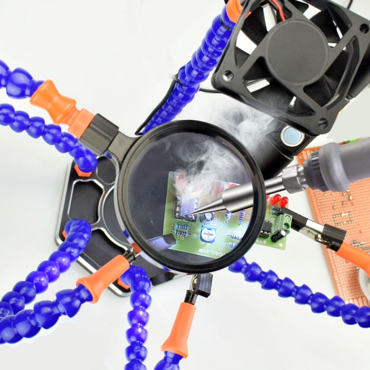 Welding station magnifier focusing on circuit board with blue light arms and fan housing