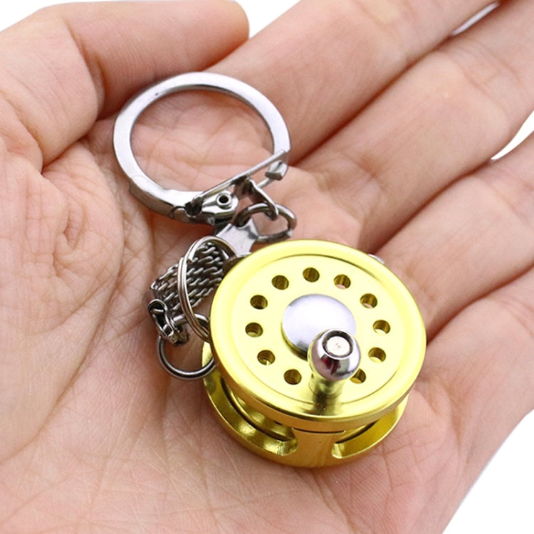 Mini fishing wheel key chain on hand: gold perforated spool with key ring
