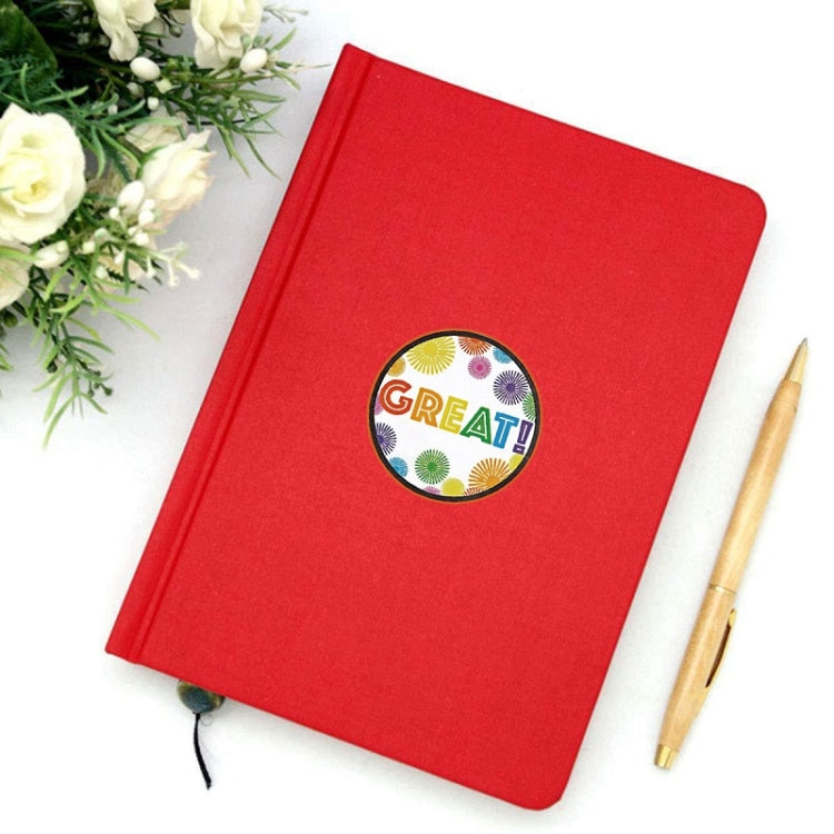 Single circular GREAT! sealing sticker on a red notebook cover