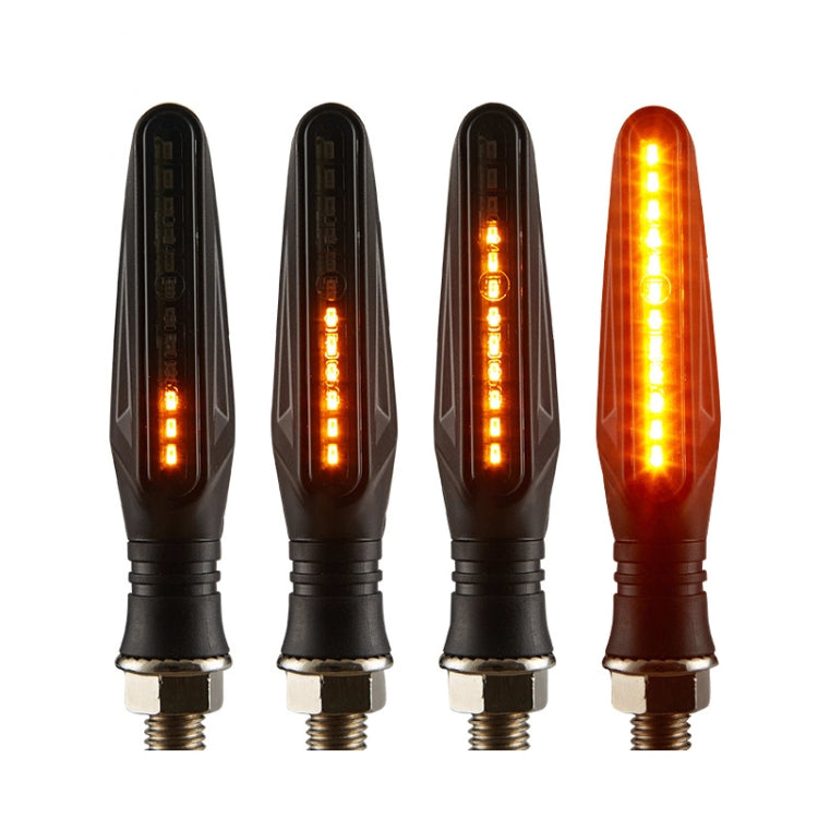 Set of four motorcycle LED signal lamps lit, black housings with bright amber LED bars