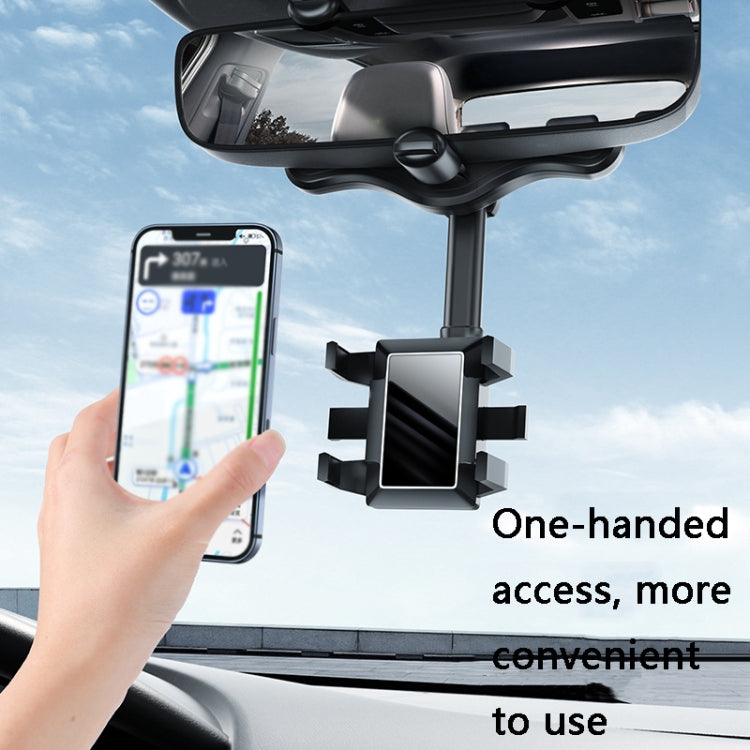 Hand placing a phone into a rearview mirror holder for easy access