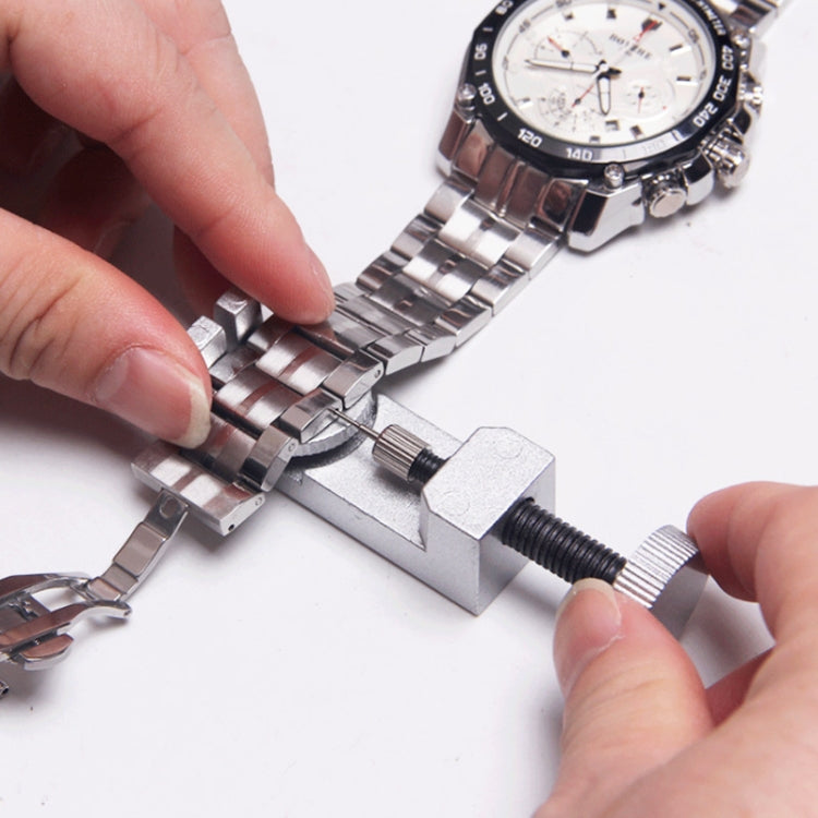 Watch lug remover tool placed on metal watch bracelet with spring bar pin