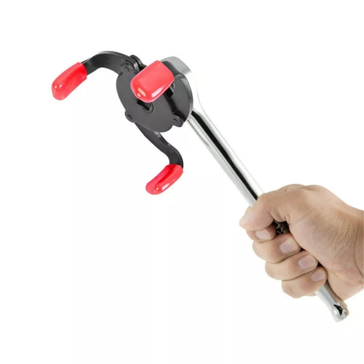 Three-jaw oil filter wrench with red claw pads and long handle, gripped for use
