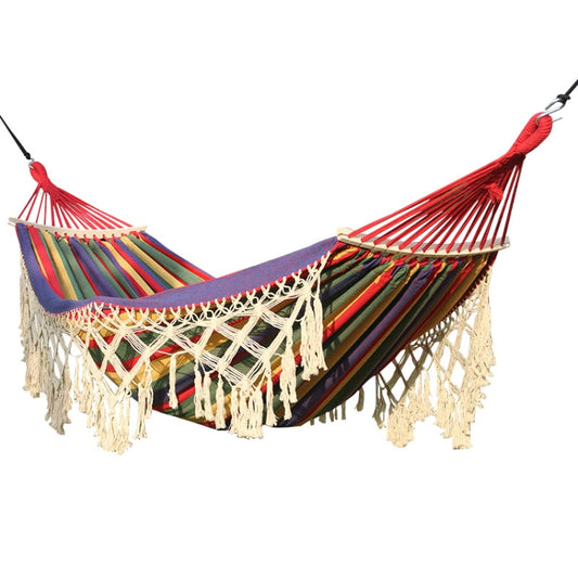 Double outdoor canvas hammock with colorful striped fabric and cream fringe tassels.