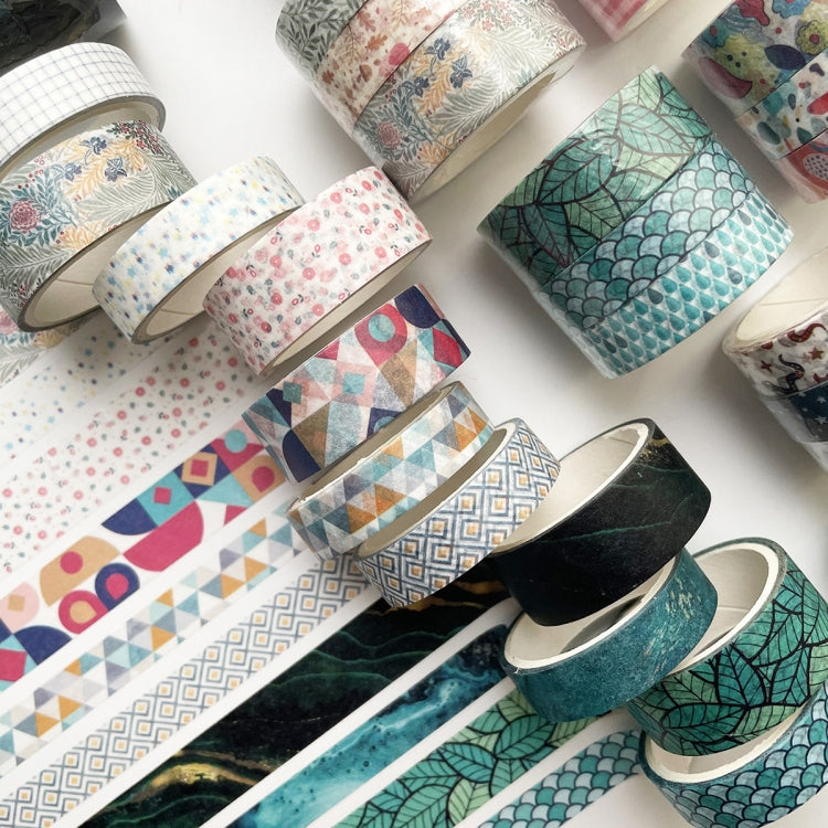 Assorted decorative washi tape rolls with teal leaf, geometry, and dark galaxy patterns
