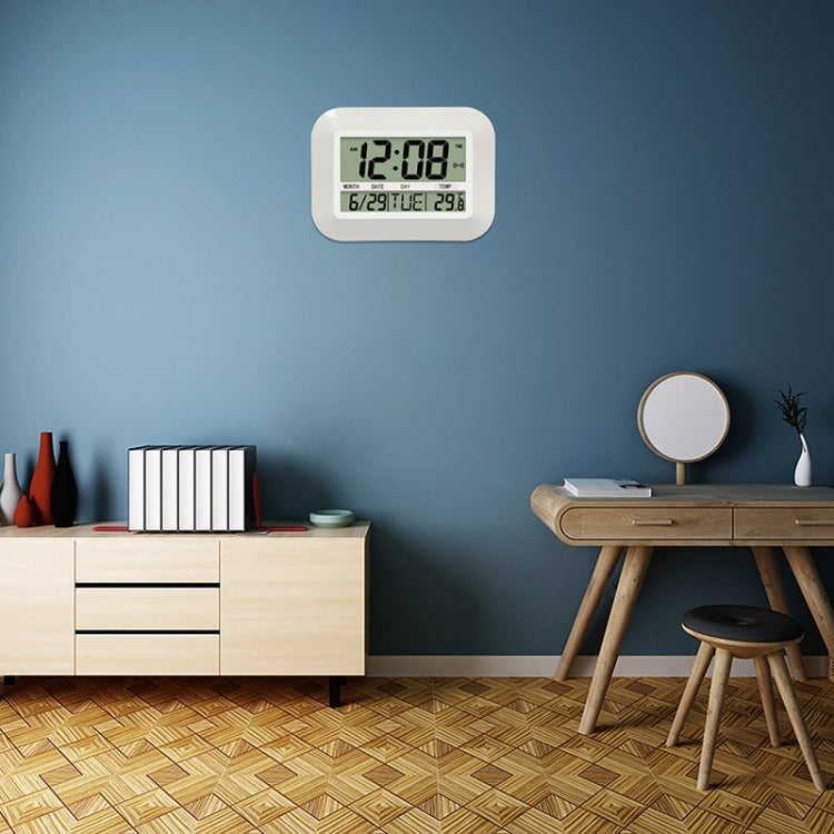 Small wall-mounted digital alarm clock with LED time and date, white housing