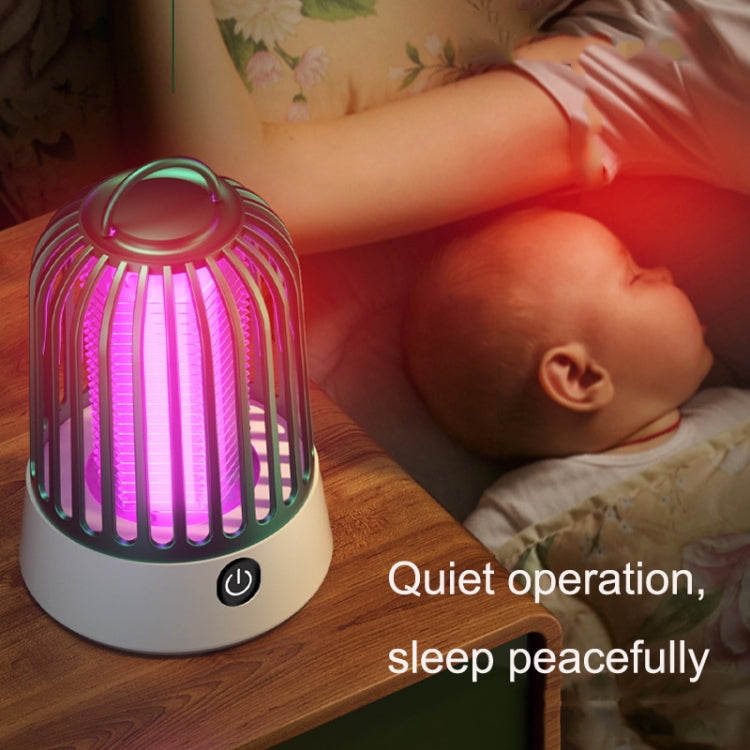 Mosquito repellent lamp with pink glow on bedside near sleeping baby