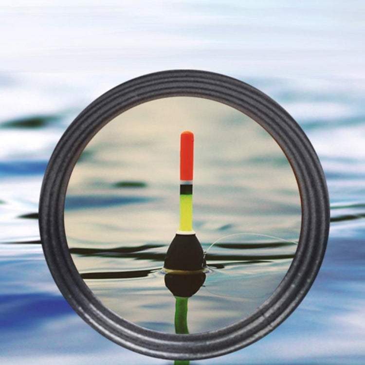 Magnified view through binocular lenses showing a fishing float on water